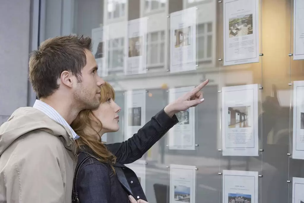 young couple looking at house needing Residential & Commercial Conveyancing